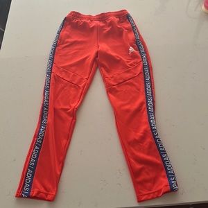 Youth medium adidas Tiro pants, bright orange with blue piping